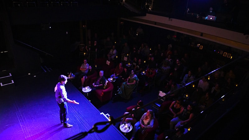 Host Danny Neely speaking on stage